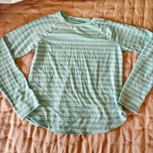 Athleta Girl light blue long sleeve performance tee with white stripes.